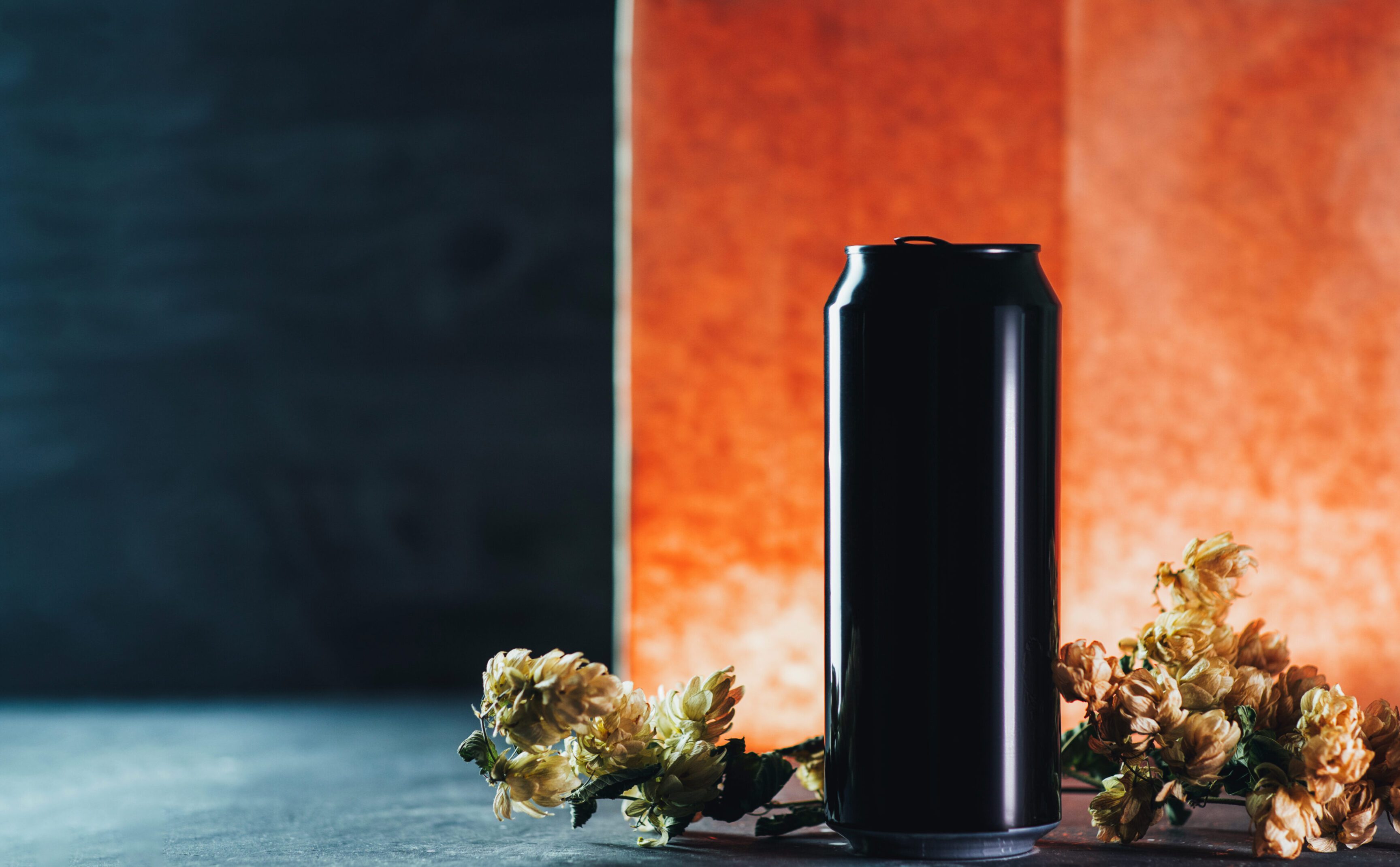 Aluminum black Craft Beer Can on the table with dry hops